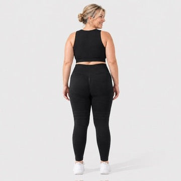 Woman wearing Finally Fit™ anti-cellulite leggings in black, back view, lifted, contoured rear