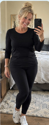 Illustrative smartphone selfie, older woman in black leggings