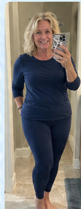 Illustrative mirror selfie, mature woman in navy leggings