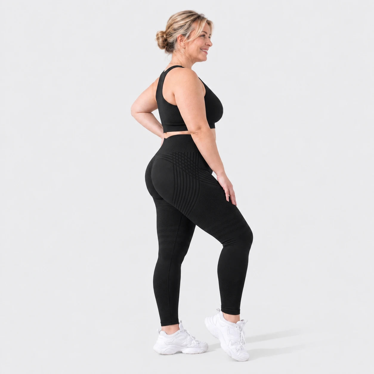 Woman wearing Finally Fit™ anti-cellulite leggings in black, side view, showing the 3D sculpt lines