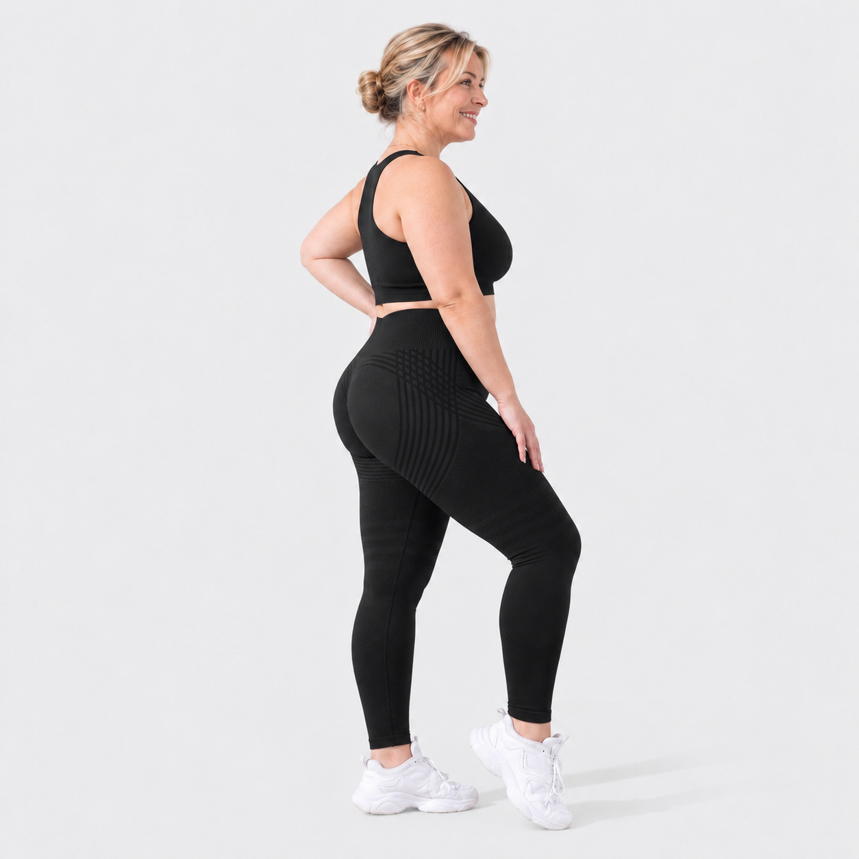 Woman wearing Finally Fit™ anti-cellulite leggings in black, side view, showing the 3D sculpt lines